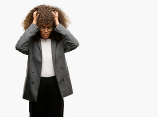 African american business woman wearing glasses suffering from headache desperate and stressed because pain and migraine. Hands on head.