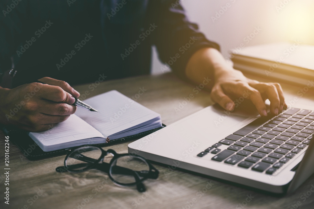 Poster professional at work, businessman writing report and using laptop working analysis investment connec