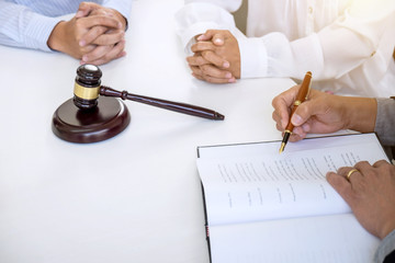 Close up of gavel, Male lawyer or judge Consult with client and working with Law books, report the...