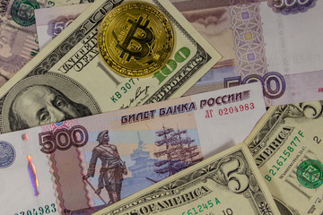 Golden bitcoin on background of us dollars and russian rubles