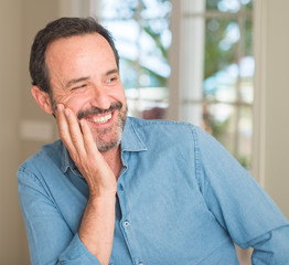 Handsome middle age man with a happy face standing and smiling with a confident smile showing teeth