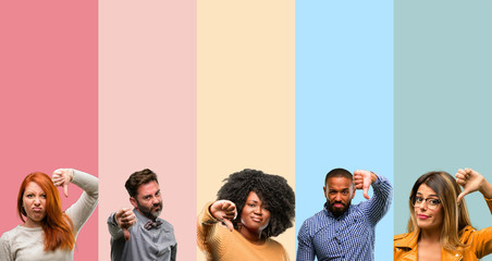 Cool group of people, woman and man showing thumbs down unhappy sign of dislike, negative expression and disapproval - obrazy, fototapety, plakaty
