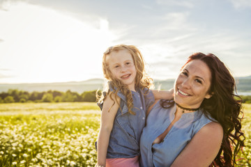 Mother spending time with daughter during the sunset.