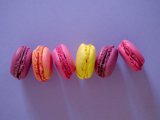 colorful macaroons, almond cookies, pastel colors, vintage card, with place to add text, purple background