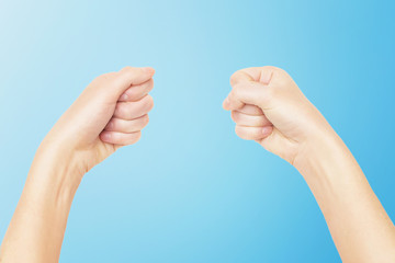 Closeup mockup of empty female hands making holding gesture isolated at blue background.