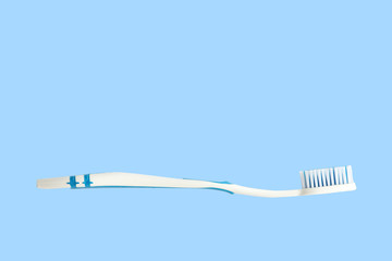 Toothbrush. Concept photo with copy space. Soft bristle toothbrush. Isolated. Blue background.