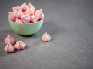 Colorful meringues in a mint green bowl