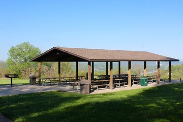 The picnic shelter with a view of the river in the park.