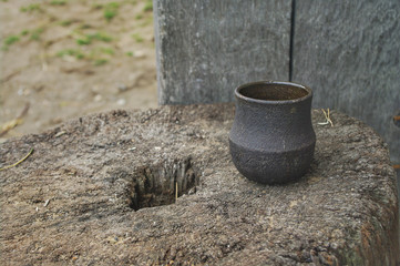 A Saxon / Viking style pottery cup on a tree stump.