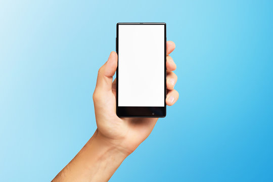 Mockup of male hand holding black frameless cell phone with blank screen isolated at blue background.