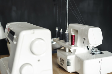 two white sewing machines on the seamstress's desk