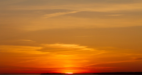 Beautiful sunset over the sea. The concept of a colorful sky: at sunset with a twilight colored sky. Bright sunset over the horizon