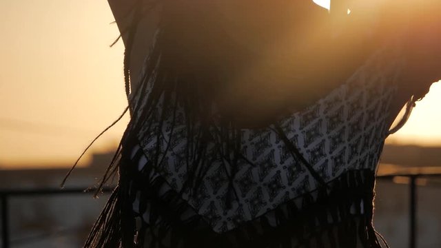 Dancing Female. silhouette happy mixed race woman dancing performance with long dreadlocks in shorts on sunset background