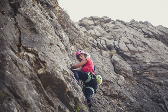 Woman Climbing a Mountain