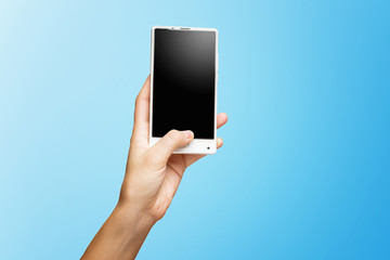 Mockup of female hand holding frameless cell phone with black screen isolated at blue background.