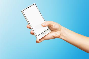 Mockup of female hand holding frameless cell phone with blank screen isolated at blue background.
