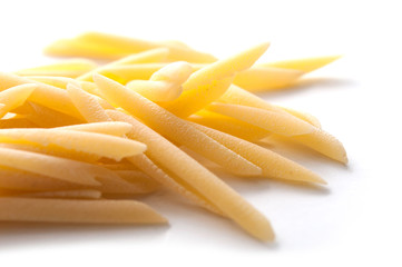 closeup of penne pasta on white background