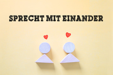 zwei Figuren mit Herzchen und die Nachricht "Sprecht mit einander"