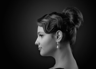 Portrait of a beautiful woman with perfect hair and  pearl earrings .