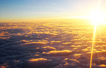 View of clouds at sunset from plane window