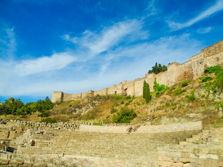 Fototapeta na wymiar Alcazaba, the fortress palace and citadel with ruins of roman theatre in Malaga, Spain. Beautiful blue summer sky.