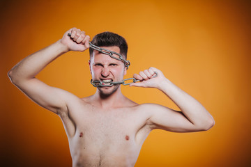 Fototapeta premium Man in captivity of his thoughts.Businessman with chained hands looking for way out of his difficulties. Healthy teeth