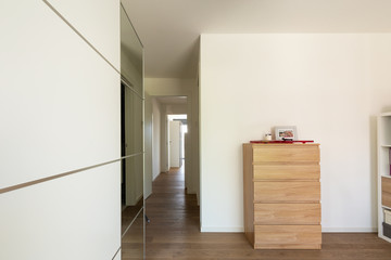 Room detail with wardrobe, chest of drawers and hallway