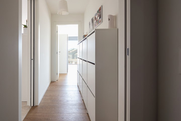 Corridor with chest of drawers and city view