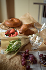 Still life, food and drink concept. Breakfast with croissants, fruits and champagne. Selective focus