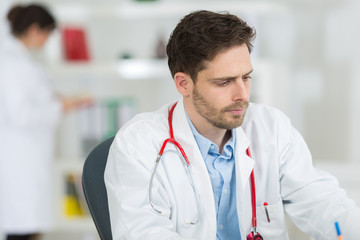 handsome young doctor at work in his office