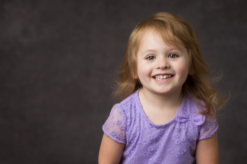 Happy Smiling Little Girl In Purple Dress