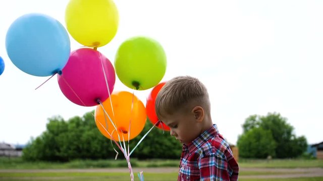Happy boy plays with balloon in the Park. Walking and outdoor activities