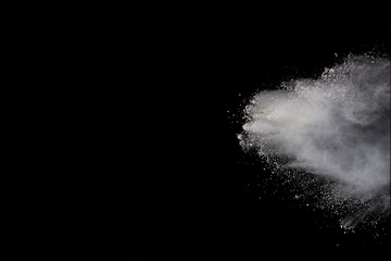 Launched white powder, isolated on black background.