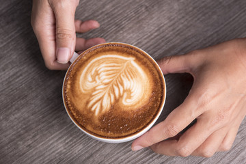latte or Cappuccino with frothy foam, coffee cup top view on table in cafe.