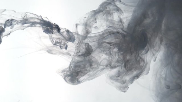 Cloud of ink floating slowly in water
