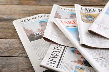 Newspapers on wooden background
