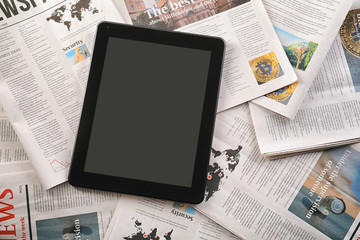 Tablet computer on newspapers