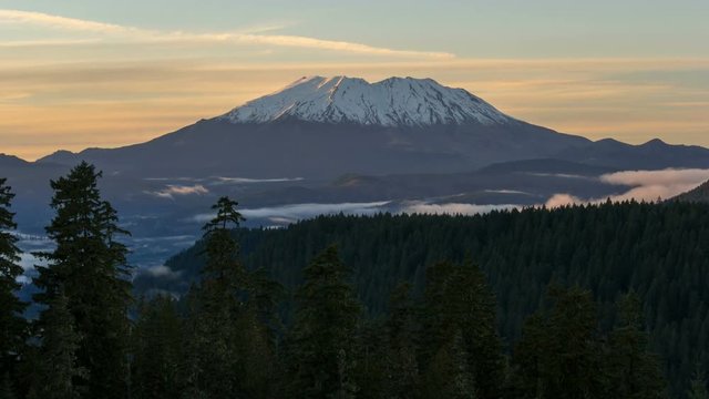 Ultra high definition time lapse video of white moving clouds over snow covered Mt St Helens during sunset in Washington state 4k UHD