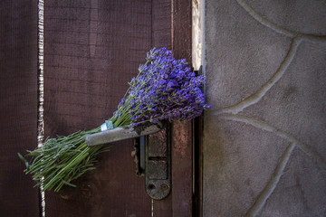 Bouquet of lavender on the lock of vintage door. Close up.