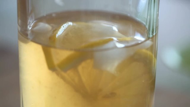 Close-up of a glass with a lemon and ice.