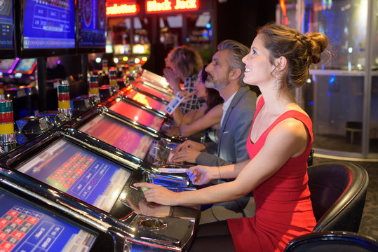 Woman playing machine in casino