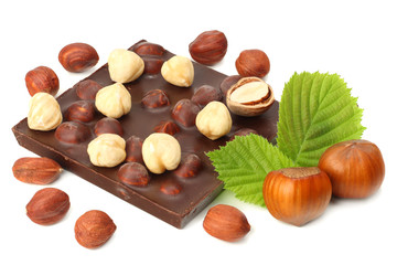 chocolate with hazelnuts and leaves isolated on white background