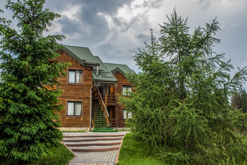wooden cottages facade in forest mountain nature environment