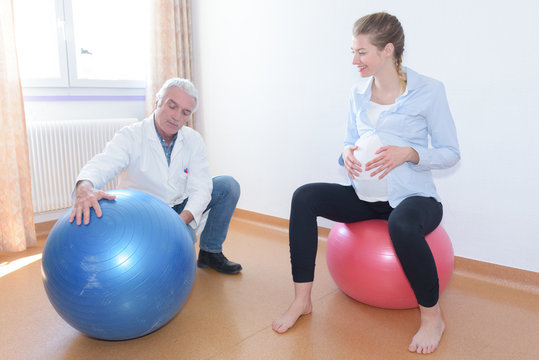 pregnant sitting on exercise ball breathing in a clinc