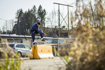 Skateboarder Doing a LipSlide On Barrier 