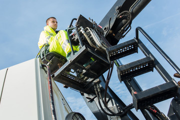 worker examines gates and cranes