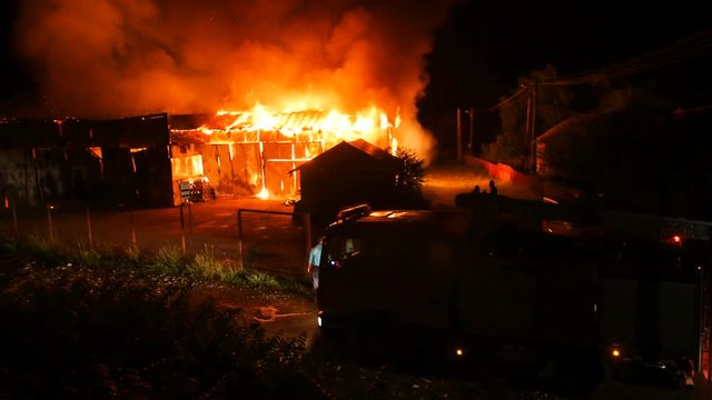 Fire Truck In Front Of A Burning House
