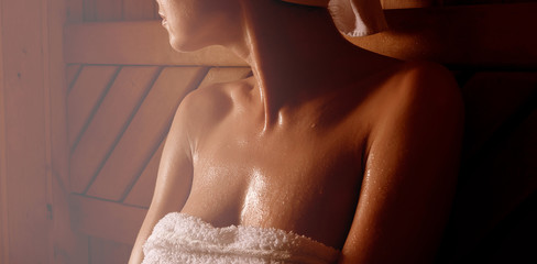 girl in a spa treatment in a traditional sauna with a brush for skin and a washcloth. relaxes...