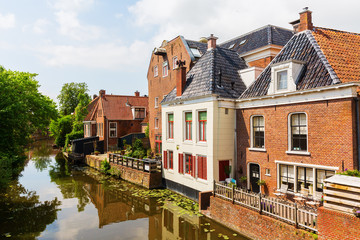 Fototapeta na wymiar canal with old buildings in Appingedam, Netherlands