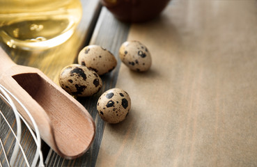 Quail eggs, scoop and parchment on kitchen table. Bakery workshop